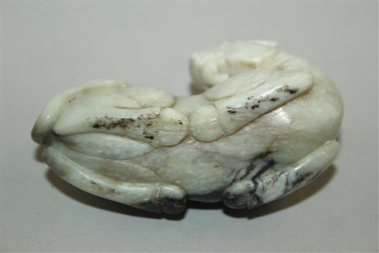 A Chinese white and black jade carving of a recumbent Bactrian camel, in Song dynasty style, 8.5cm